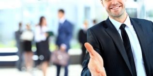 Portrait of a successful businessman giving a hand