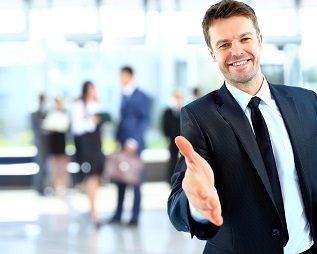 Portrait of a successful businessman giving a hand