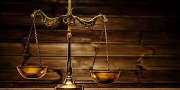Brass scales over wooden background
