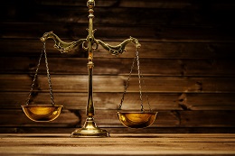 Brass scales over wooden background
