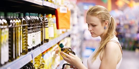 Young woman buying olive oil