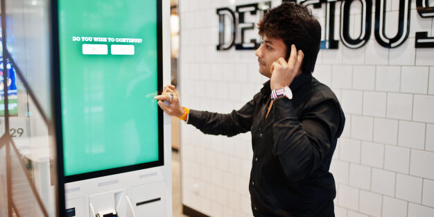 you-wish-continue-indian-man-customer-store-place-orders-pay-through-self-pay-floor-kiosk-fast-food-payment-terminal-his-thinking-choise_151355-4601